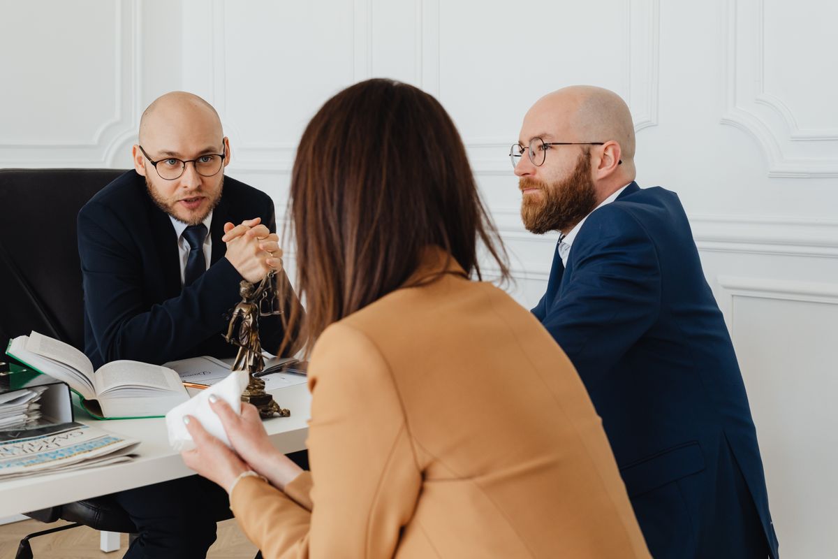 People discussing paperwork together around an office table