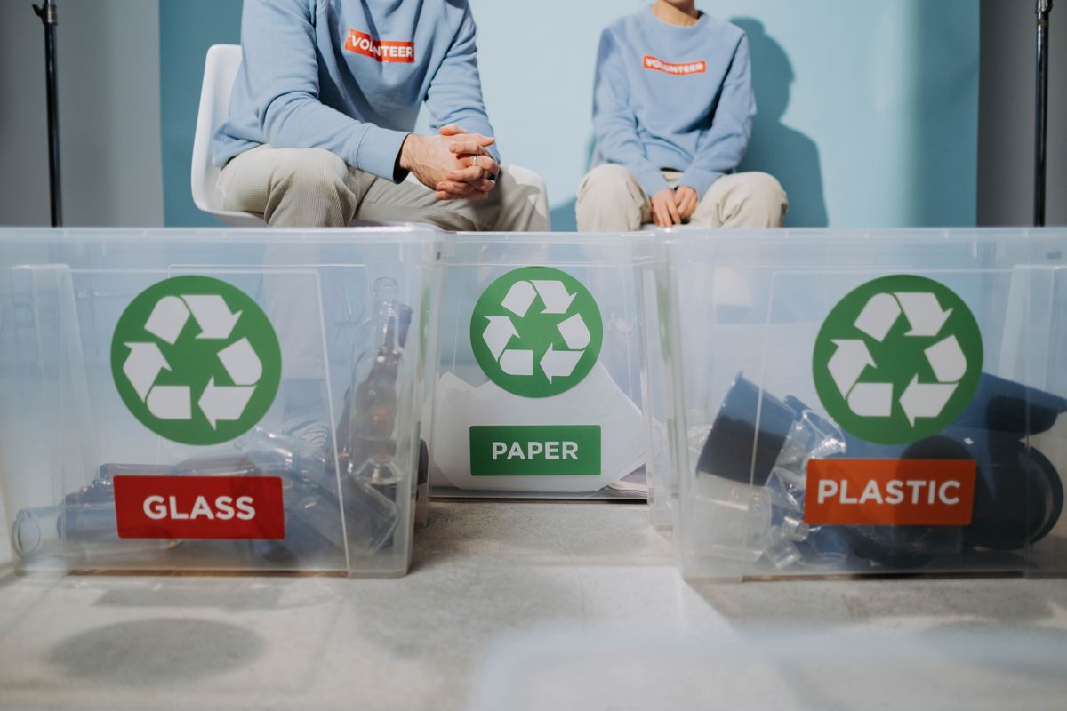 Volunteers sorting glass, paper and plastic for recycling